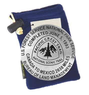 Silver Pacific Crest Trail marker with blue pouch on a white background
